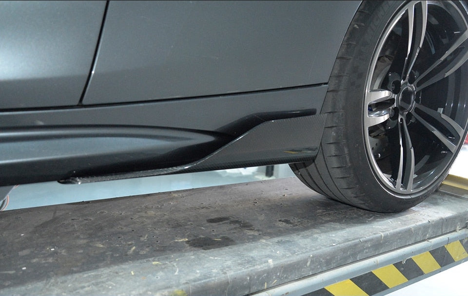 Universal M2 Style Half-Length Side Skirt Extensions - Manufactured from Pre-Preg Carbon Fibre. This product is designed to enhance the side angle of your car with the lightweight Pre-Preg Carbon Fibre composite. Fitting with fixings and bonds is recommended for this product.