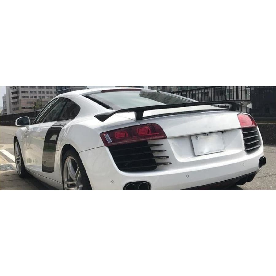 Audi R8 Carbon Fibre Rear Spoiler - Manufactured to enhance the look and drivability of the Audi R8 this Rear Spoiler wing attaches to the R8 with 4 securing bolts to ensure is stability at speed and to also transfer the downforce through to the back wheels to keep them planted in corners. 