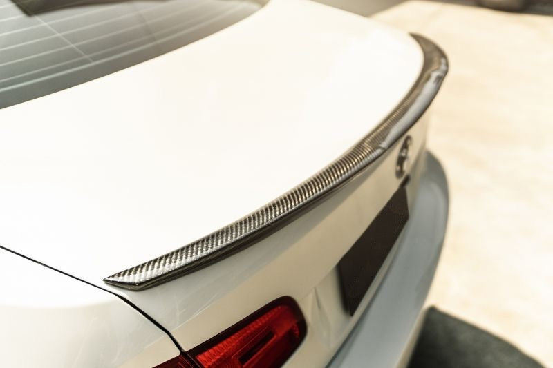 BMW M4 Style Carbon Fibre Rear Trunk Spoiler for the 3 Series and M3 E90 Saloon, E92 Coupe and E93 Convertible Models - Manufactured from 2*2 Carbon Fibre weave and designed in the M4 Styling for the BMW 3 Series and M3 Coupe and Convertible Models, This spoiler adds a distinct look to the rear of the 3 series BMW coupe and Convertible models with a signature dip through the centre of the rear spoiler adding a texturising accent the rear end.