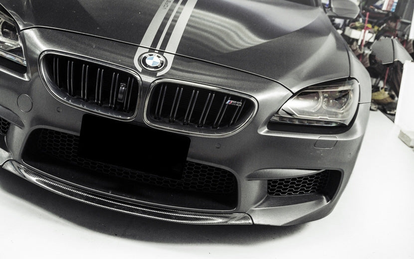 BMW M6 RKP Style Carbon Fibre Front Lip Spoiler for the F06/F12/F13 M6 BMW Models - This product inspired by the stunning RKP Styling is the perfect addition to those not looking for a full-length front lip spoiler but a more subtle look with the way this product nestles its self in between the bumper splitters and sits tight with the shapes already produced with the M6 front bumper. 