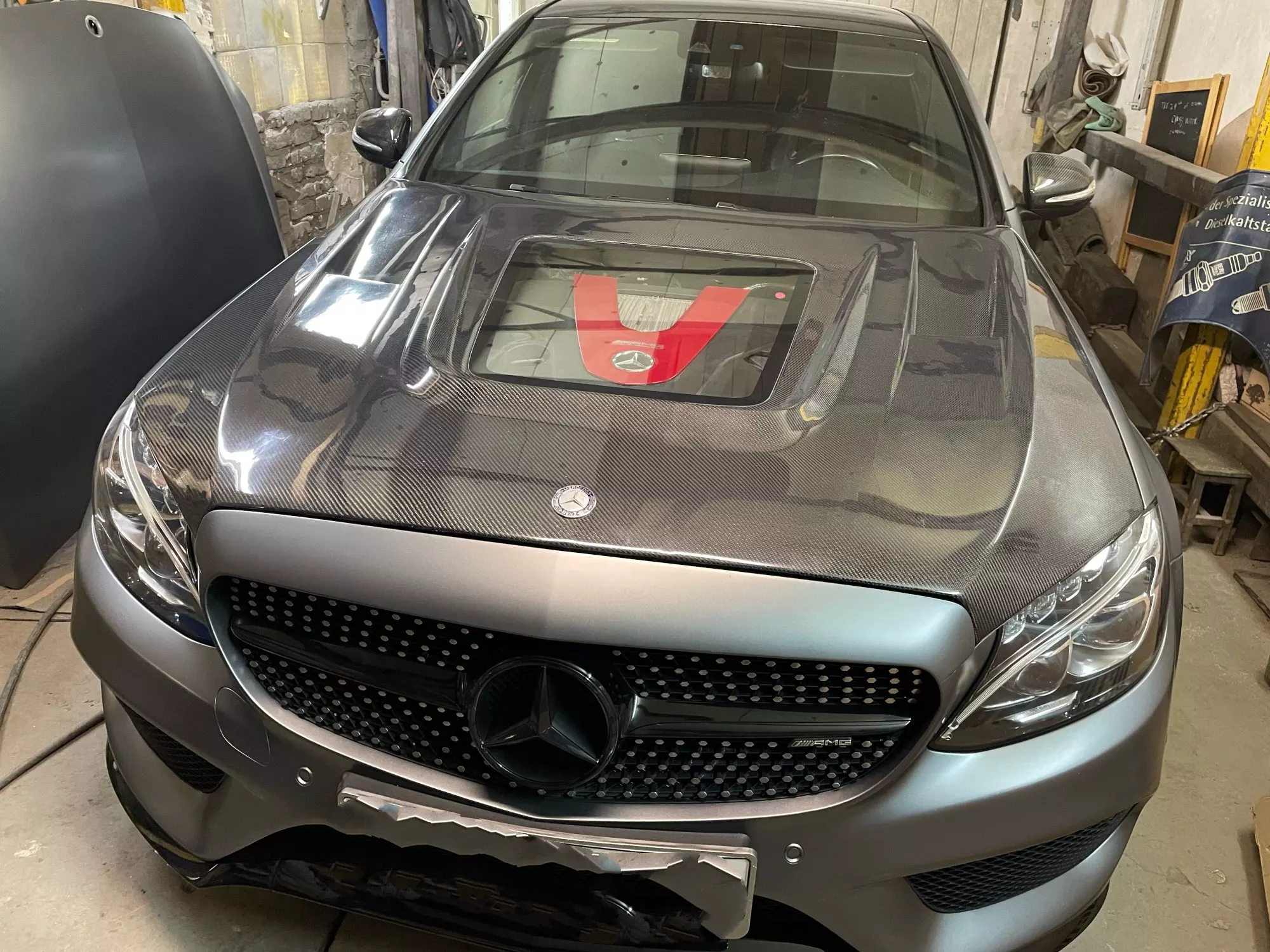 Mercedes C Class W205 Saloon Full Carbon Fibre Hood/Bonnet Replacement For the C43/C63 and AMG Line Models between 2015-2018 - Designed to show off that gorgeous engine bay in the C43/C63 Models and goes perfectly with Carbon Fibre Engine covers. The Perspex Centre Window creates the look of aggression when coupled with the more aggressive style of this Carbon Fibre Bonnet/Hood Replacement. 