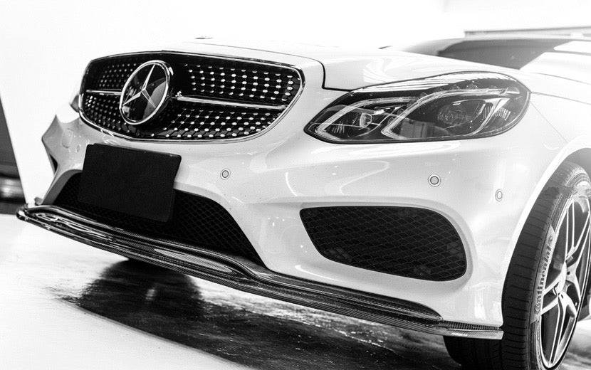 Mercedes Benz E-Class AMG Line (W212) Future Design GT Style Carbon Fibre Front Lip Spoiler for the LCI Facelift E-Class Models from 2013. This product is designed to fit the AMG Line Models and will not install to the E55 or E63 Models. Manufactured from 2*2 Carbon Fibre weave in the Future Design Styling for the E-Class W212 Saloon Models. This product enhances the front of your E-Class with a subtle touch of carbon to the lower bumper.
