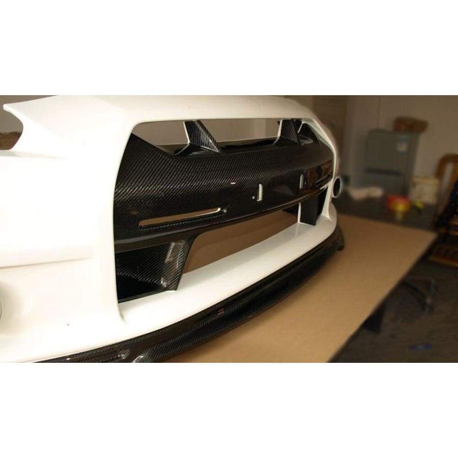  Nissan GTR R35 Carbon Fibre Add-on Front Bumper Centre Trim - Manufactured from 2*2 Carbon Fibre Weave. This product attaches over the bumper's centre section to enhance the front visual and give a more aesthetic look to the aggressive front bumper on the R35 GTR Models. 
