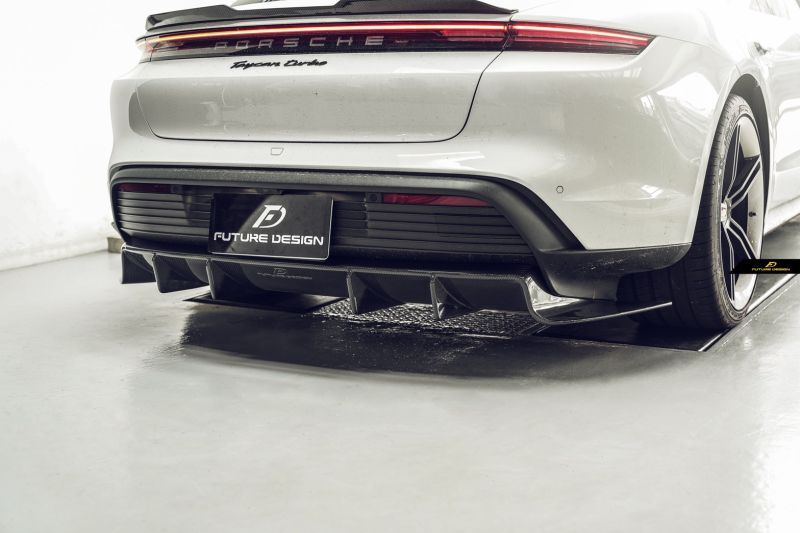 Porsche Taycan Saloon Future Design Carbon Fibre Rear Diffuser - Manufactured from 100% Carbon Fibre and designed to enhance the Porsche Taycans looks with additional Aesthetic carbon fibre to the Rear of this Taycan Model. This product is part of the new line of carbon fibre parts for the all-electric Porsche series. This product has a distinct Future Design Styling creating a more aggressive look to the rear of the Porsche Taycan especially when paired with the Future Design Rear Spoiler.